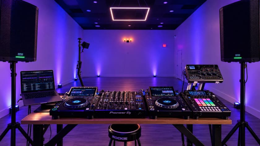 The Club Stack in the room: two CDJ-3000X players, a DJM-A9 mixer, a DJS-1000 sampler, and the RMX-IGNITE, with the PA on stands